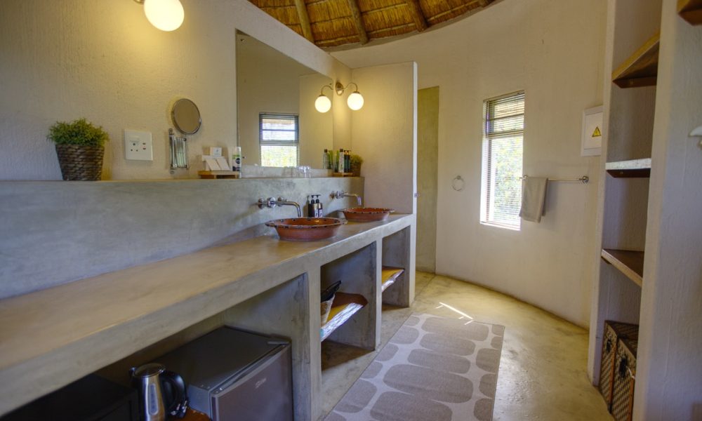 Lengau Lodge - Kruger National Park - Kudu luxury Rondavel room - double XL bed mosquito netting, dressing table, private terrace with view to waterhole