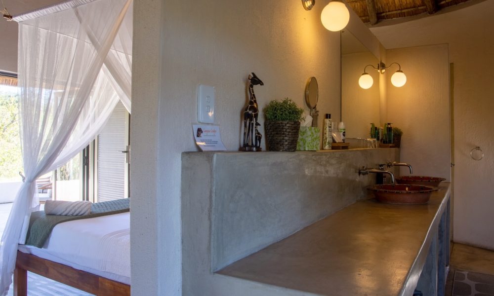 Lengau Lodge - Kruger National Park - Kudu luxury Rondavel room - double XL bed mosquito netting, dressing table, private terrace with view to waterhole